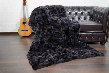 Rabbit Blanket Throw Rex Gray Orchid - Tatifurs draped on a couch with a guitar in the background, showcasing its luxurious texture.