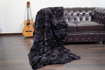 Rabbit Blanket Throw Rex Gray Orchid - Tatifurs draped on a couch with a guitar nearby, showcasing its luxurious texture.