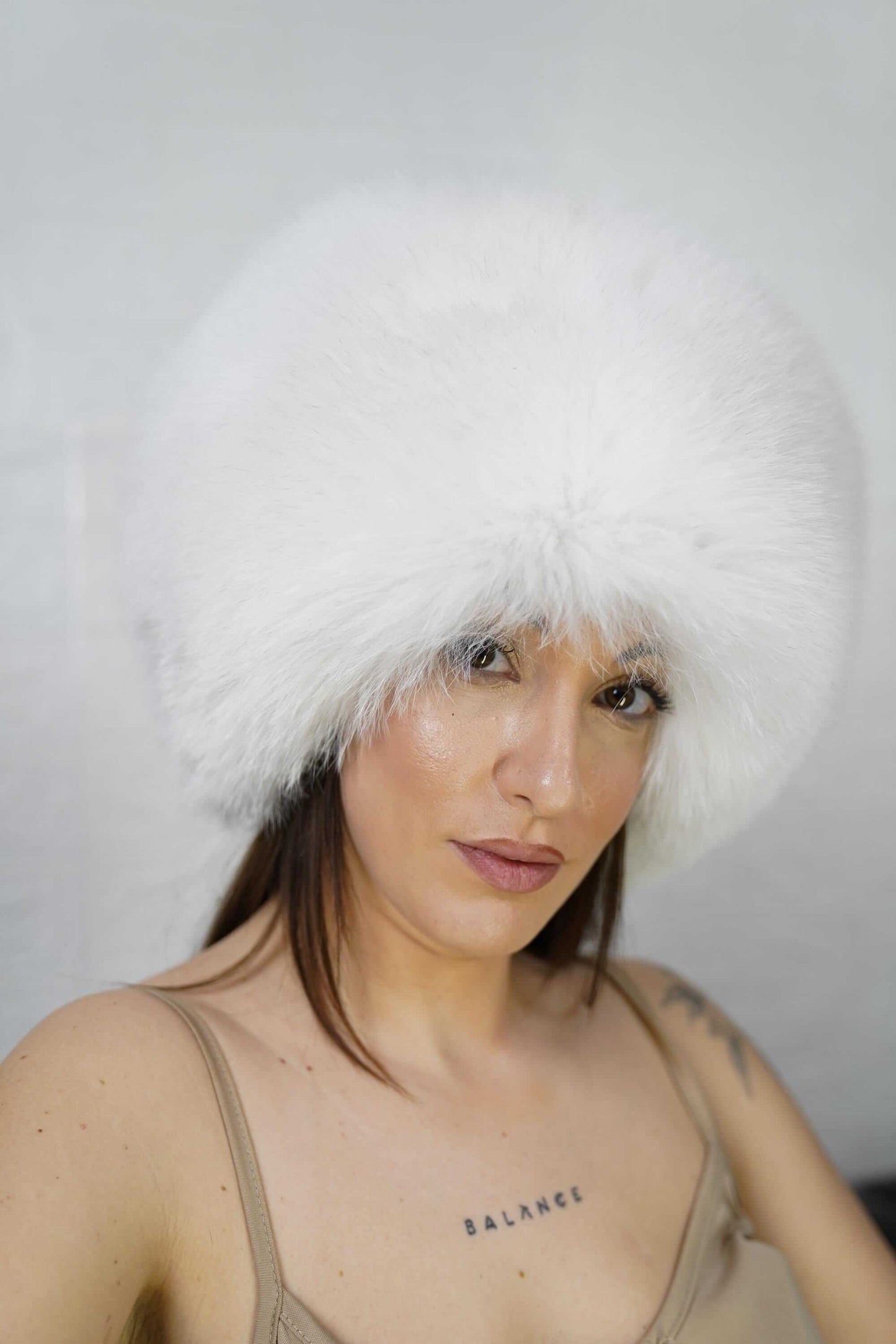 Fox Fur Hat White Full Skin - Tatifurs worn by a woman, showcasing its luxurious pure white fur.