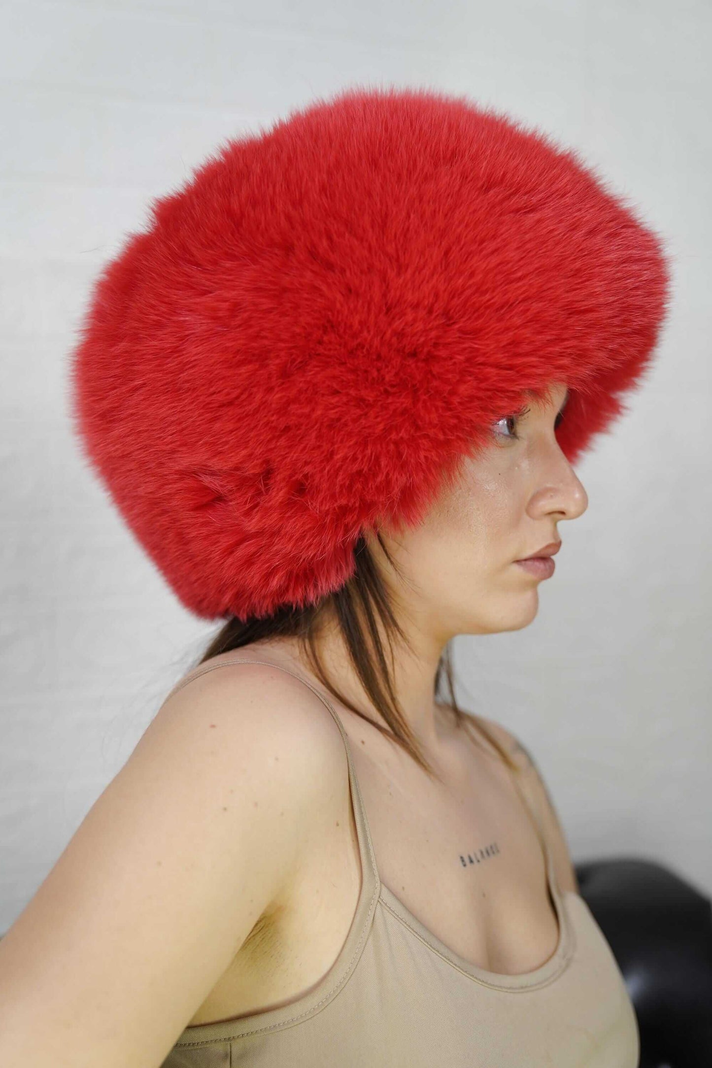 Fox Fur Hat Red Full Skin - Tatifurs displayed on a model, showcasing its luxurious look and adjustable fit.