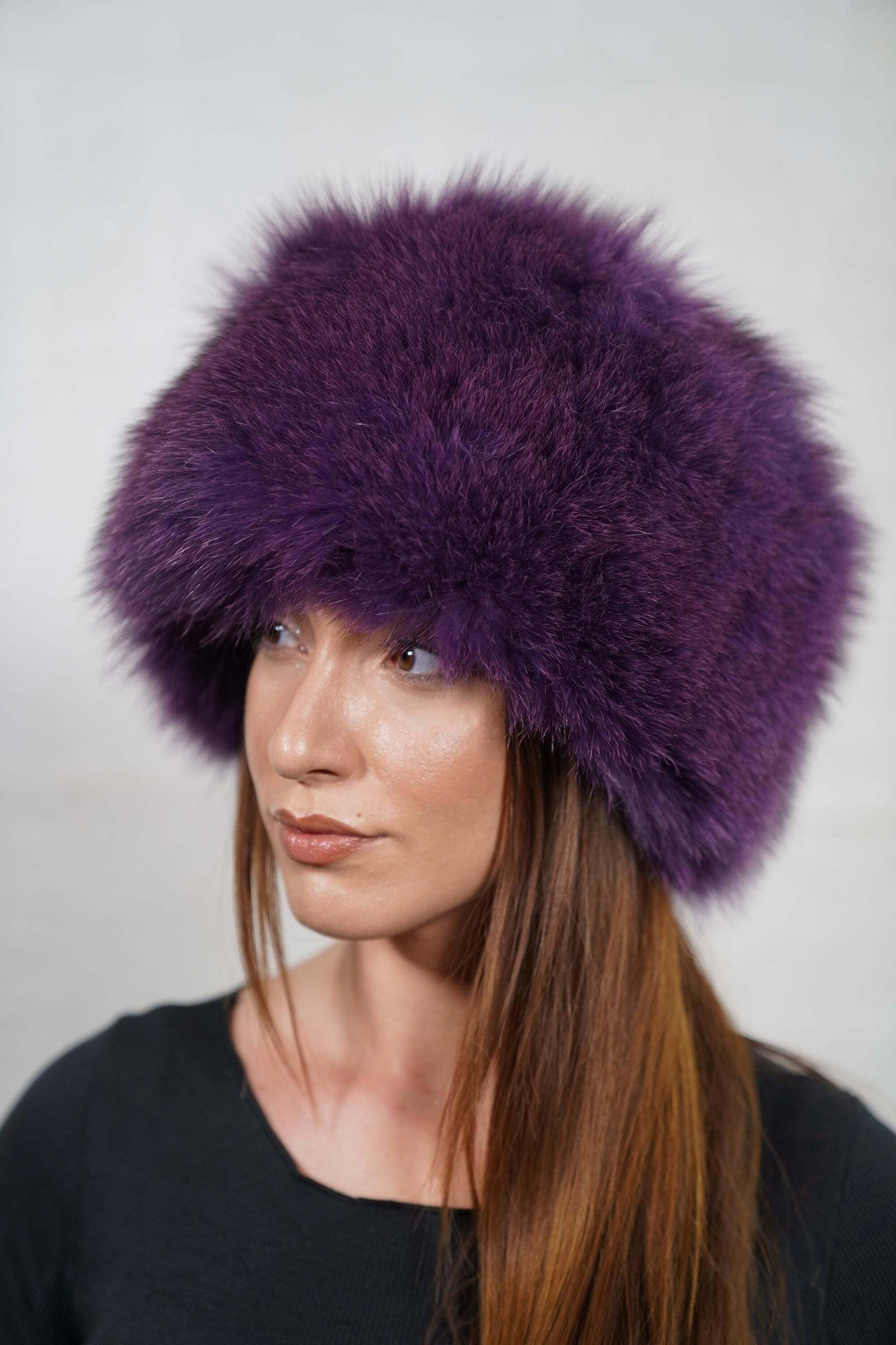 Fox Fur Hat Purple Full Skin - Tatifurs displayed on a model, showcasing its luxurious and cozy design.