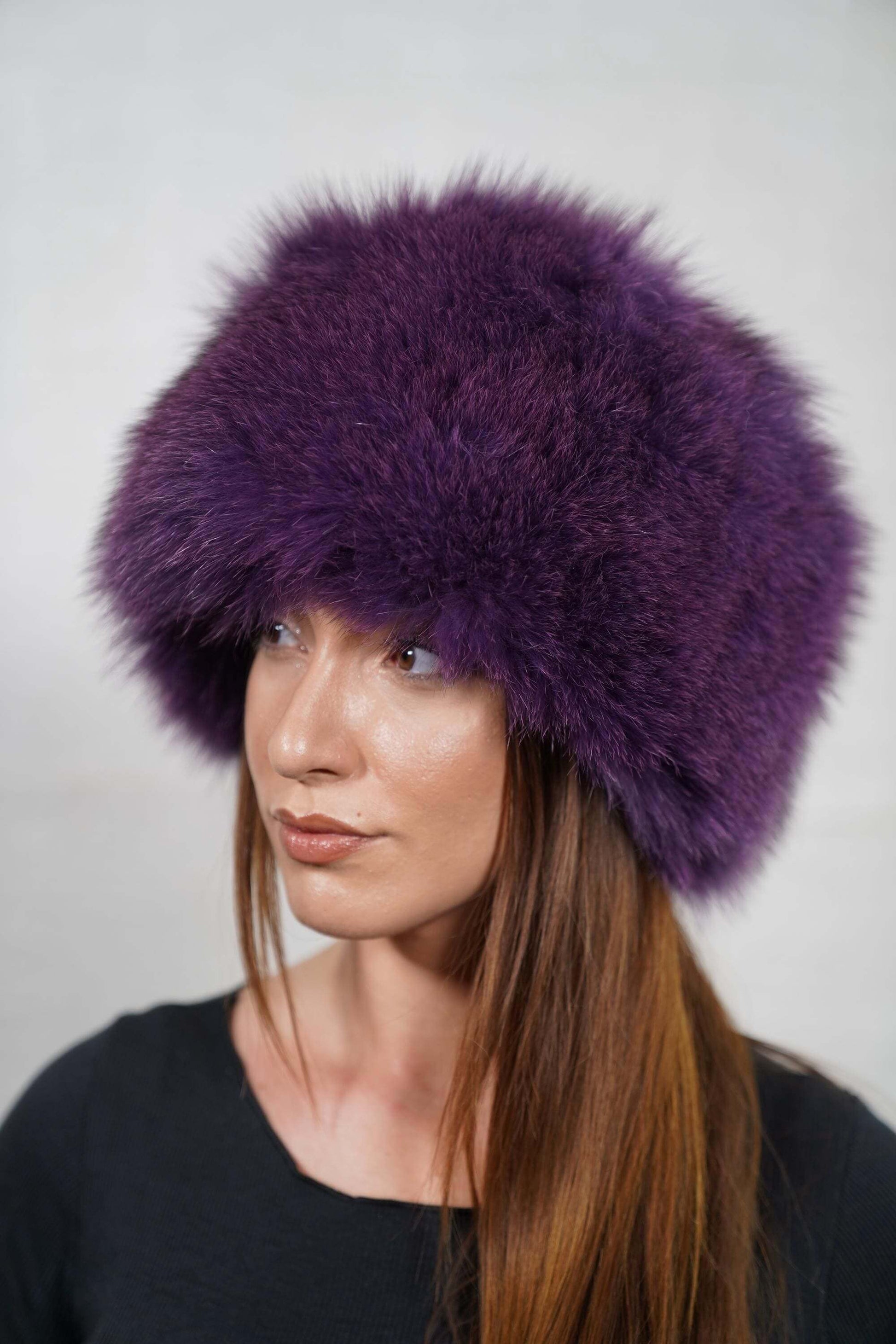 Fox Fur Hat Purple Full Skin - Tatifurs displayed on a model, showcasing its luxurious and cozy design.