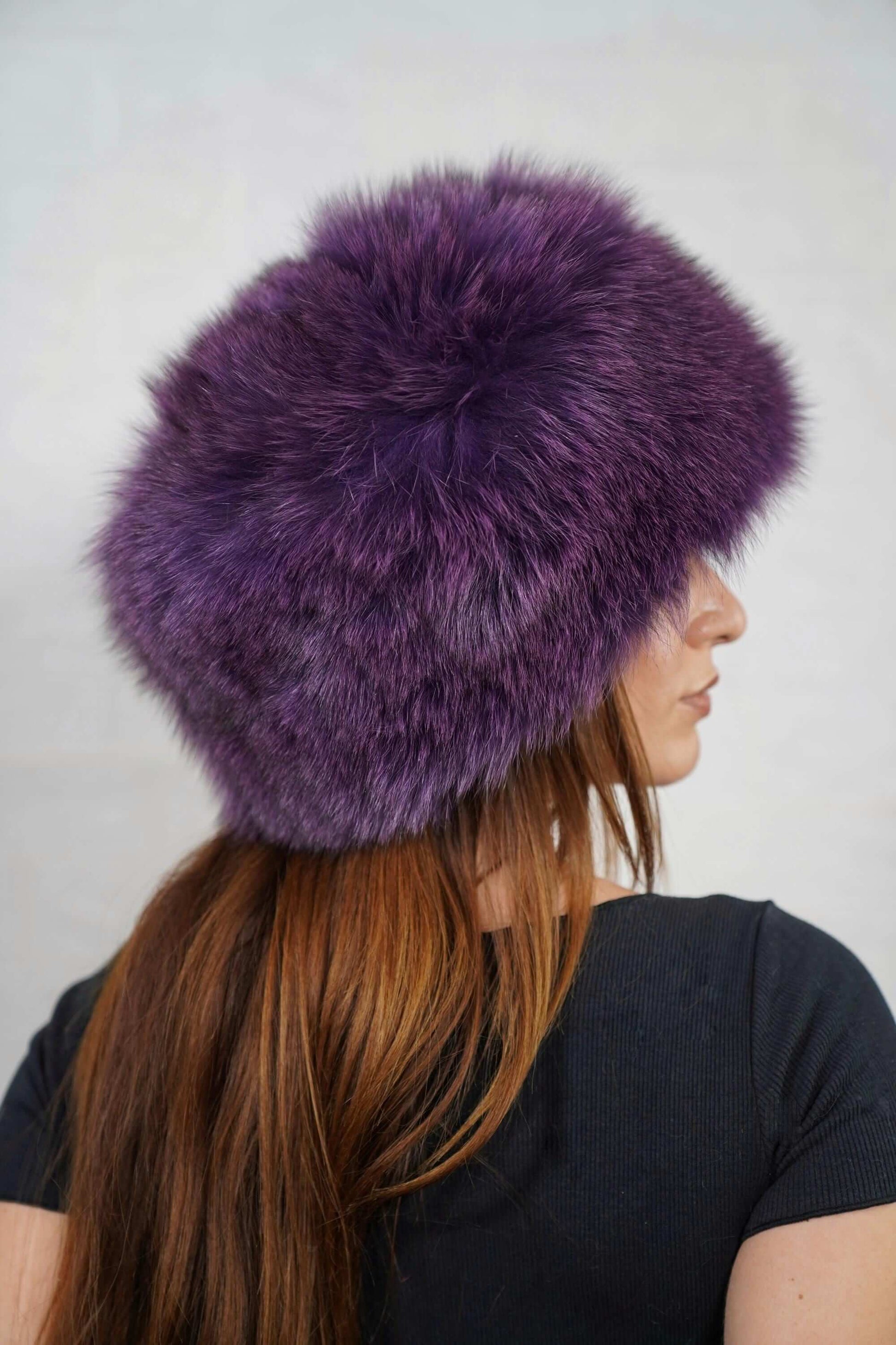 Fox Fur Hat Purple Full Skin - Tatifurs worn by a woman, showcasing luxurious purple fur and stylish design.