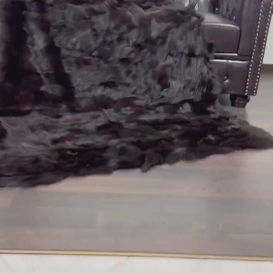 Fox Fur Blanket Throw Brown - Tatifurs draped over a chair, showcasing its luxurious texture and color.