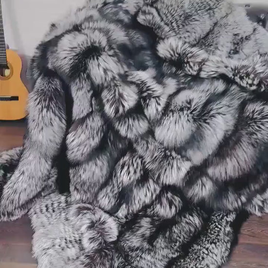 Fox Fur Blanket Throw Silver Natural - Tatifurs draped elegantly over a chair, showcasing luxurious silver fox fur texture.