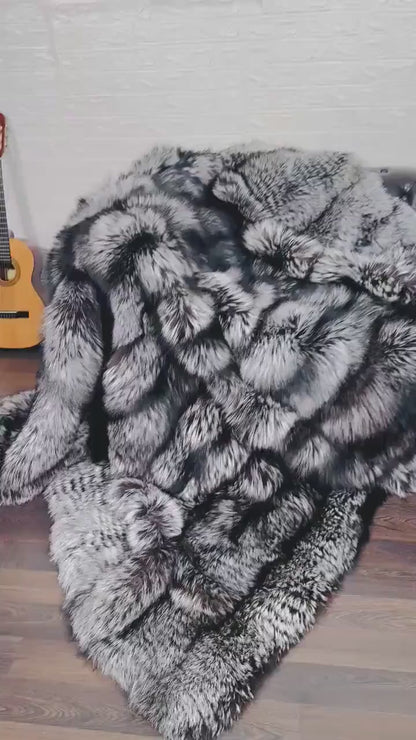 Fox Fur Blanket Throw Silver Natural - Tatifurs draped elegantly over a chair, showcasing luxurious silver fox fur texture.