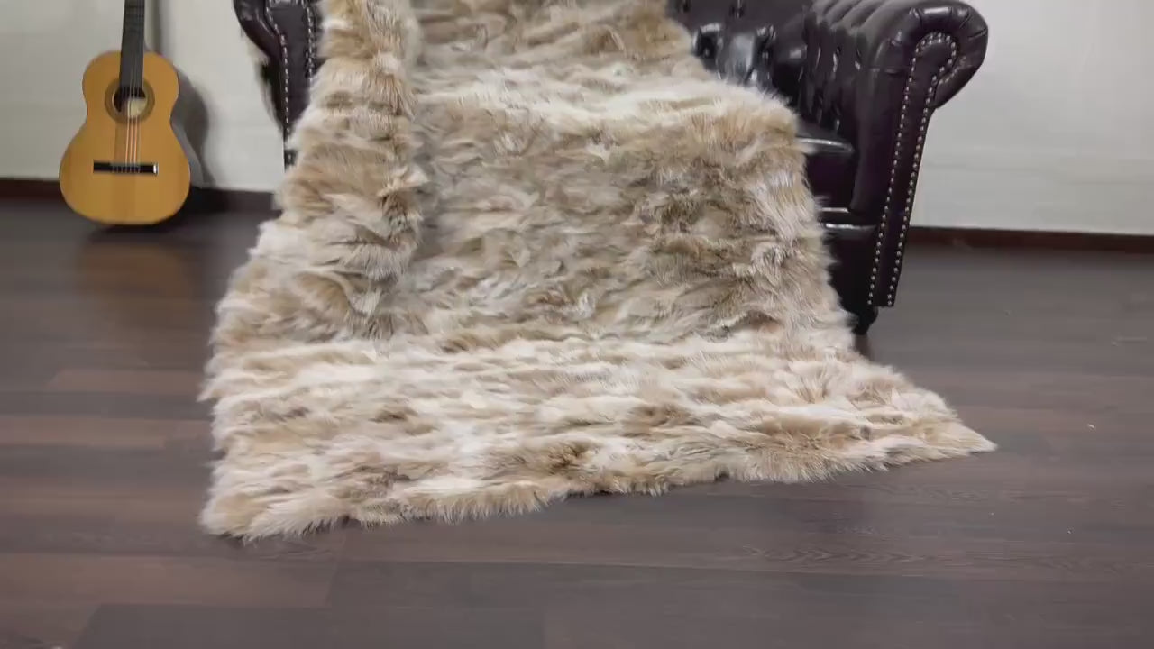 fox fur throw blanket beige — draped across cream sofa, warm beige and white against neutral base — Greek craftsmanship, TatiFurs
