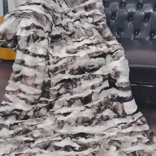 rex rabbit fur throw blanket natural black white — draped across white sofa, natural pattern against clean interior — Greek craftsmanship, TatiFurs
