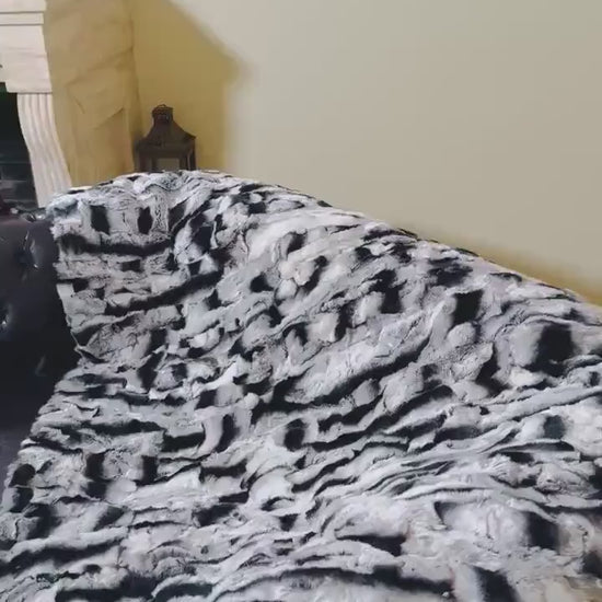 Rabbit Blanket Throw Chinchilla Rex - Tatifurs on a couch showcasing its luxurious softness and unique chinchilla coloring.