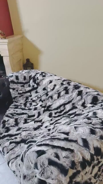 Rabbit Blanket Throw Chinchilla Rex - Tatifurs on a couch showcasing its luxurious softness and unique chinchilla coloring.