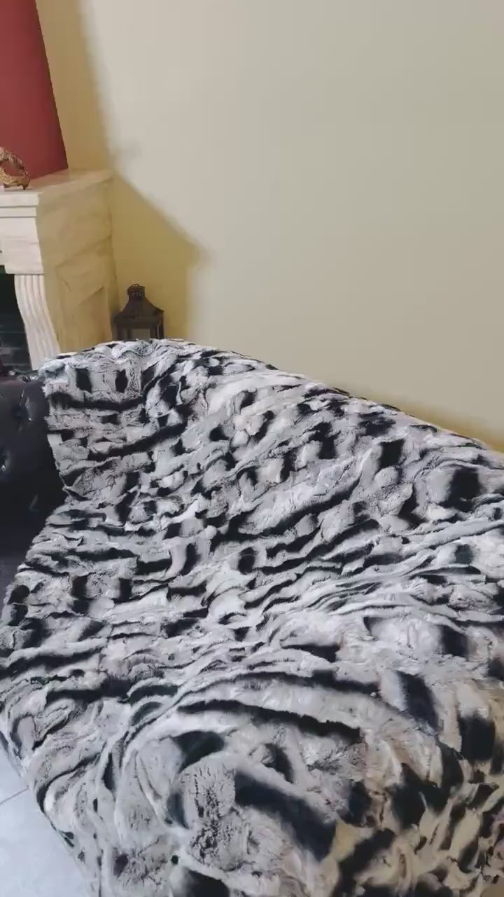 Rabbit Blanket Throw Chinchilla Rex - Tatifurs on a couch showcasing its luxurious softness and unique chinchilla coloring.