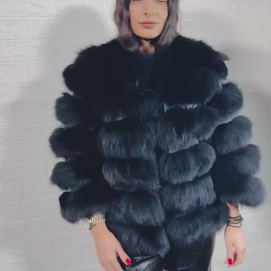 Model wearing black fox fur short jacket with leather accents
