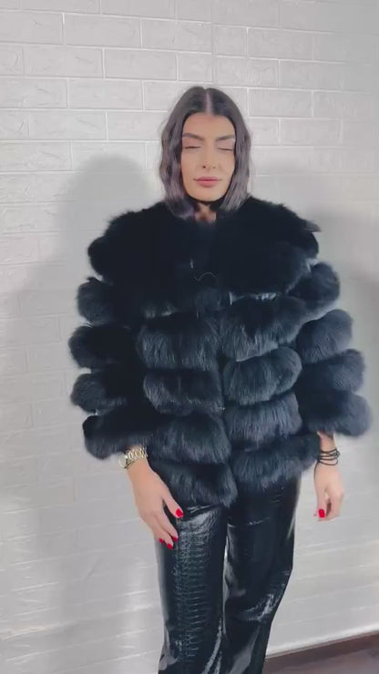 Model wearing black fox fur short jacket with leather accents
