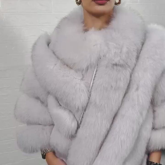 Fox fur poncho blue natural close-up texture showing full skin natural blue fox long pile and horizontal rabbit fur trim strip construction — Greek craftsmanship, TatiFurs
