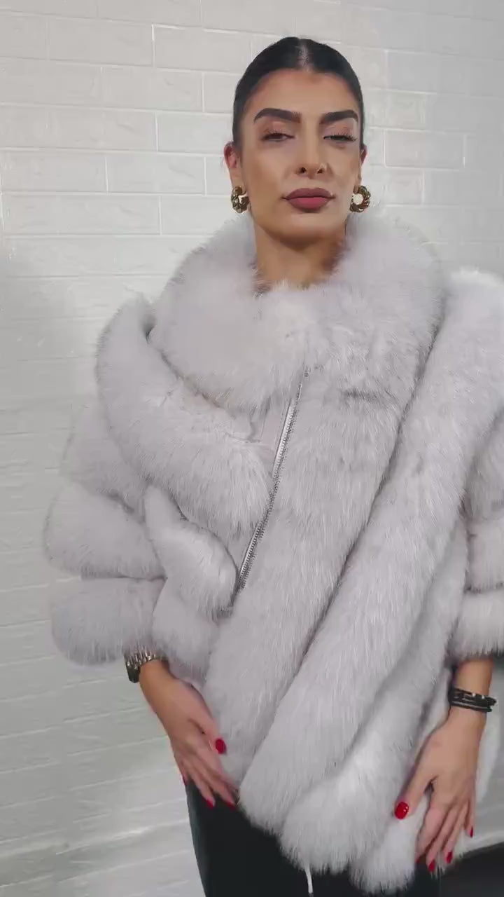 Fox fur poncho blue natural close-up texture showing full skin natural blue fox long pile and horizontal rabbit fur trim strip construction — Greek craftsmanship, TatiFurs

