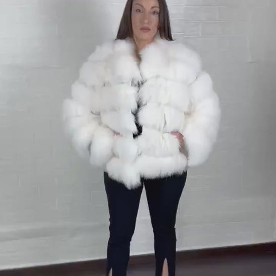 White fox fur jacket styled for a winter evening look

