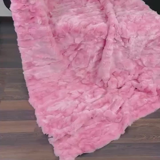 rex rabbit fur throw blanket pink — draped across white sofa, soft pink against clean base — Greek craftsmanship, TatiFurs
