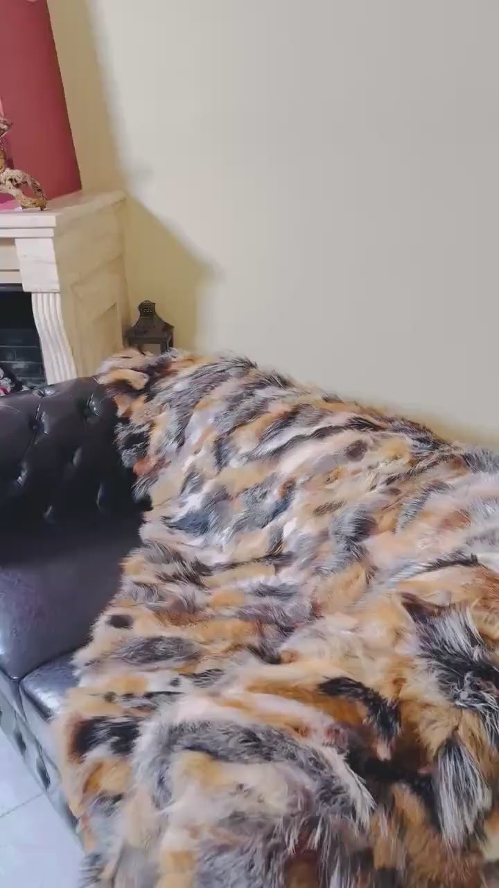 Fur Throw Blanket Natural Gross Fox – Luxury - Tatifurs draped over a luxurious couch, showcasing dramatic fur colors.