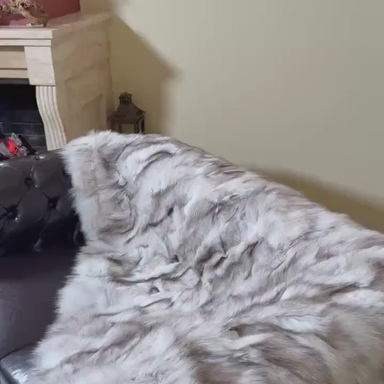 Fox Fur Blanket Throw Blue Natural - Tatifurs displayed on a stylish sofa, showcasing its luxurious texture.