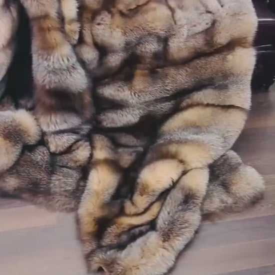 Natural Crystal Fox Fur Blanket - Tatifurs draped elegantly on a sofa, showcasing soft brownish white tones.