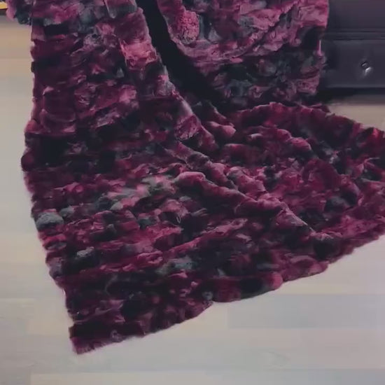 rex rabbit fur throw blanket red black — draped across dark sofa, commanding colour contrast — Greek craftsmanship, TatiFurs
