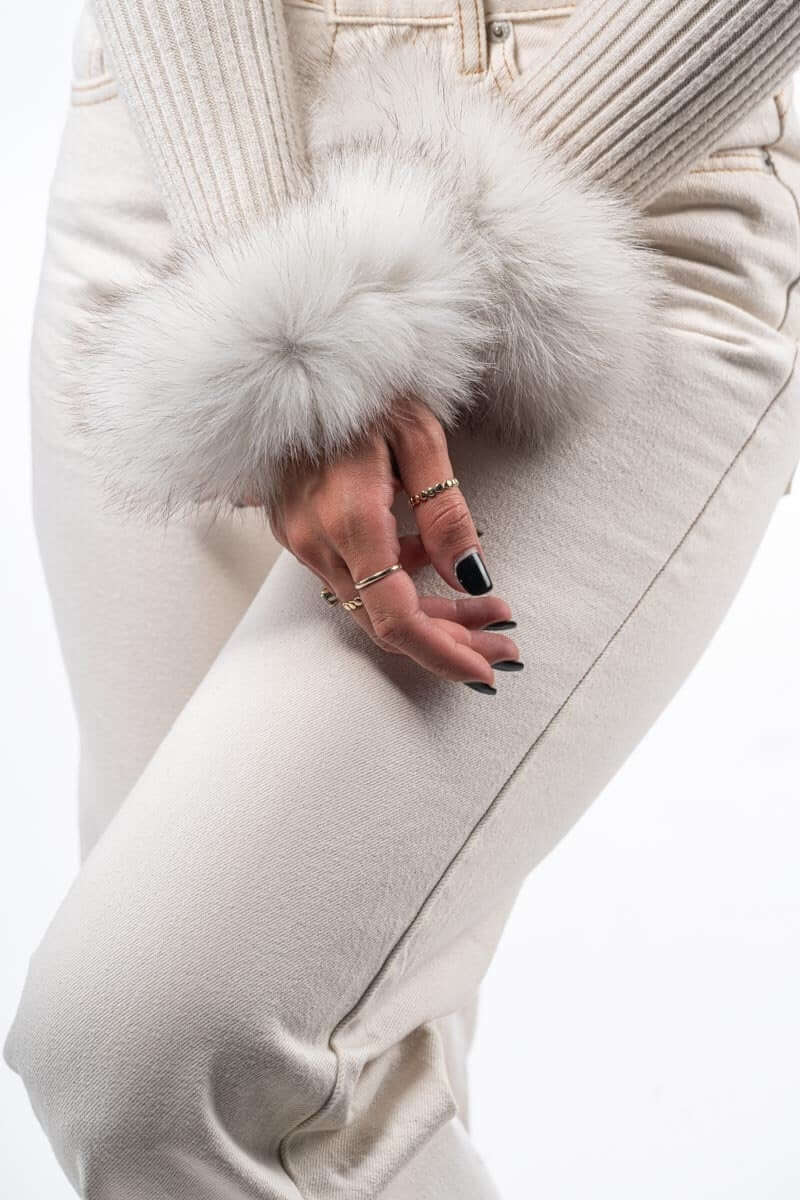 Natural Blue Fox Fur Cuffs - Tatifurs adorning stylish white outfit with elegant silver tones.