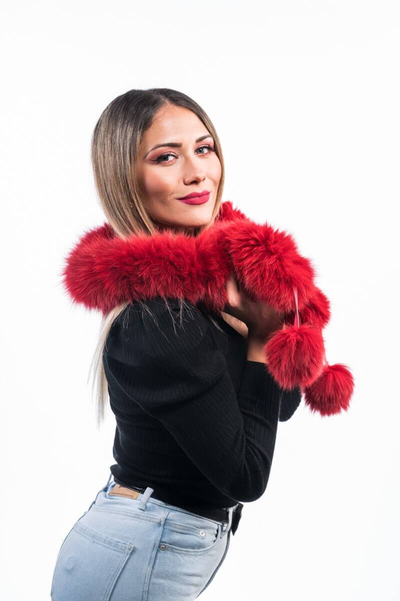 Red Fox Fur Scarf with Pom Poms - Tatifurs worn by a woman, showcasing bold red fur and playful pom poms.