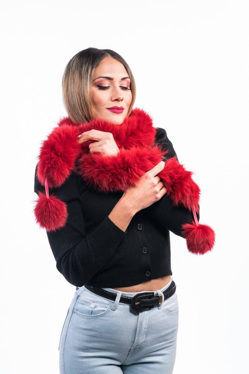 Red Fox Fur Scarf with Pom Poms - Tatifurs worn by a model, showcasing its bold red color and playful pom poms.