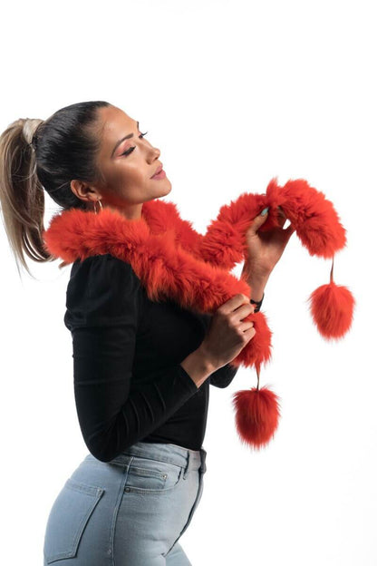 Orange Fox Fur Scarf with Pom Poms - Tatifurs worn by model, showcasing its vibrant color and playful pom poms.