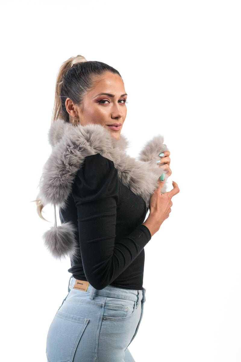 Fox Fur Scarf Gray - Tatifurs worn stylishly by a model, showcasing its softness and playful pom poms.