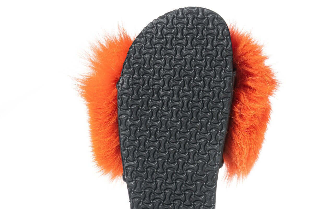 Fox Fur Slides Orange - Tatifurs, showcasing the black sole and vibrant orange fur puffs for a luxurious look.