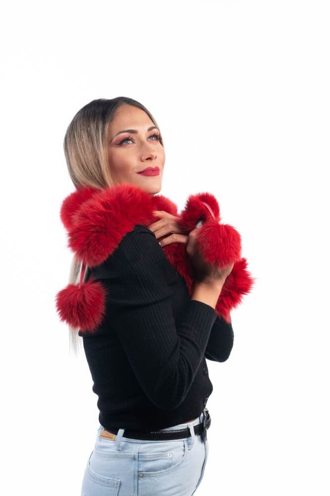 Red Fox Fur Scarf with Pom Poms - Tatifurs styled by a woman, showcasing its vibrant color and playful pom poms.
