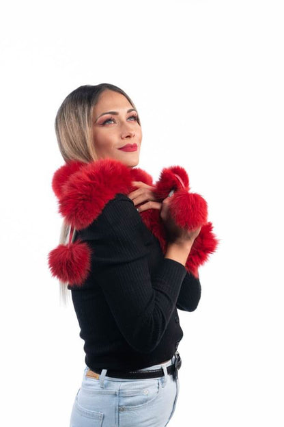 Red Fox Fur Scarf with Pom Poms - Tatifurs styled by a woman, showcasing its vibrant color and playful pom poms.