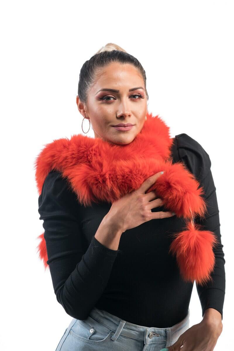 Orange Fox Fur Scarf with Pom Poms - Tatifurs worn by a model, showcasing the vibrant, fluffy texture and playful pom poms.