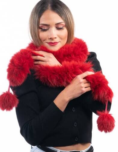 Red Fox Fur Scarf with Pom Poms - Tatifurs being worn by a model, showcasing its vibrant red color and playful pom poms.