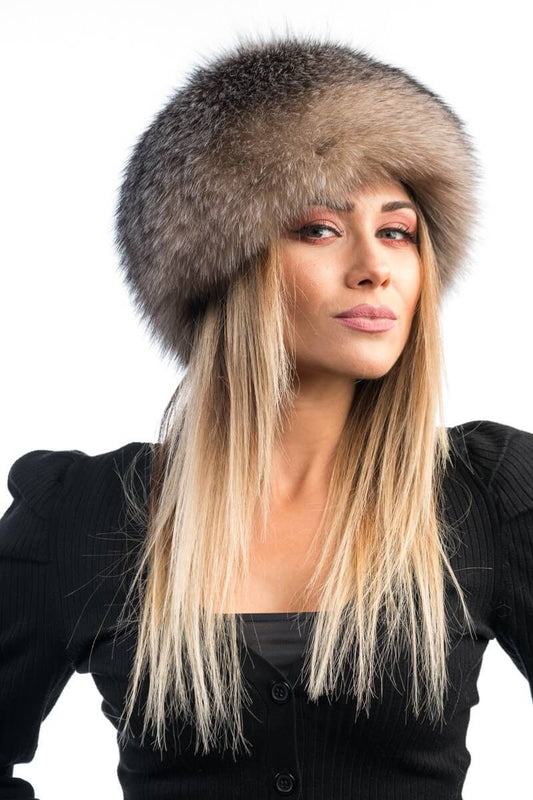Woman wearing natural crystal fox fur full skin hat showing luminous pale tones
