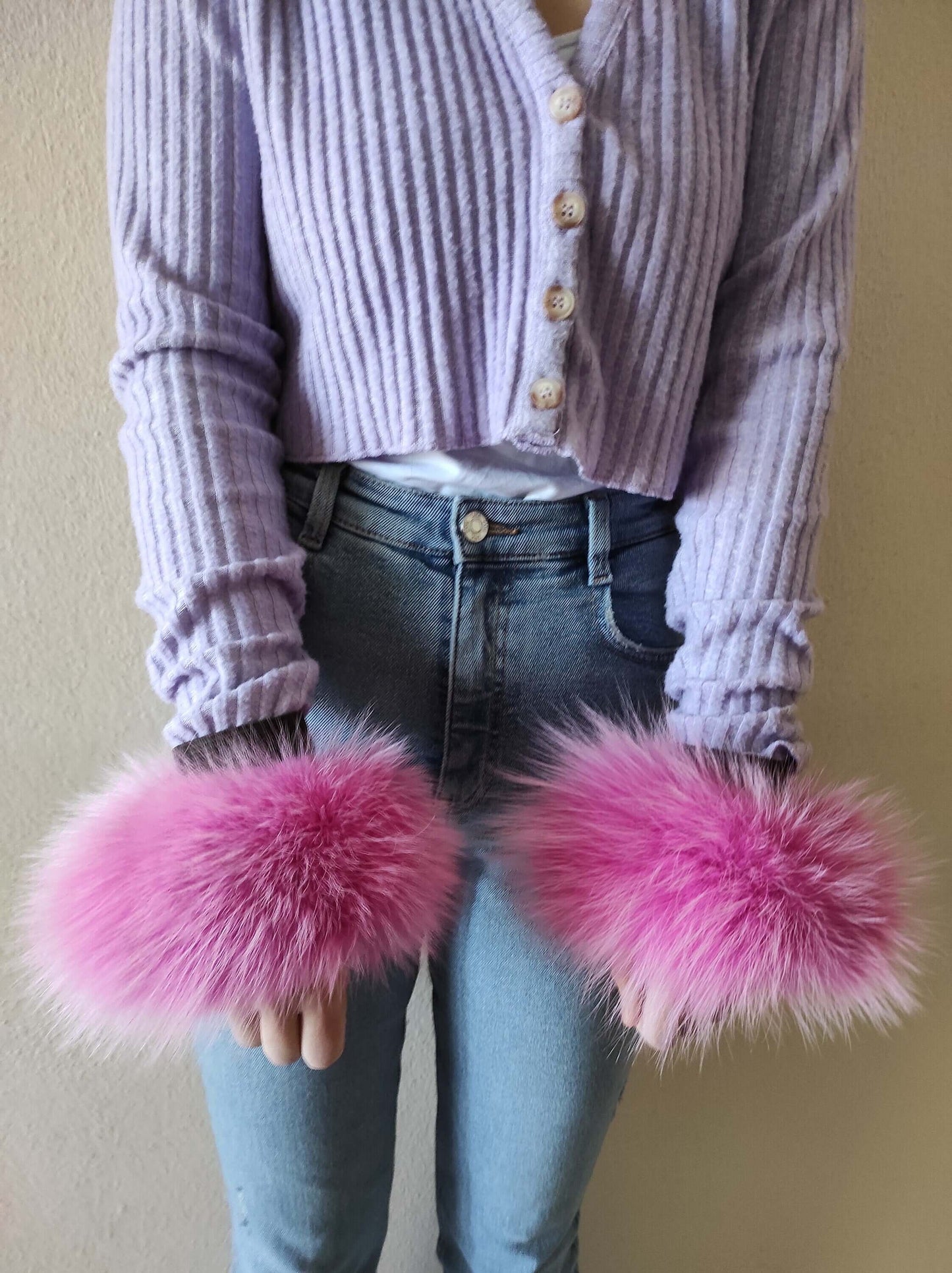 Fuchsia Fox Fur Cuffs - Tatifurs worn on wrists, showcasing vibrant fuchsia pink fur with stylish detail.