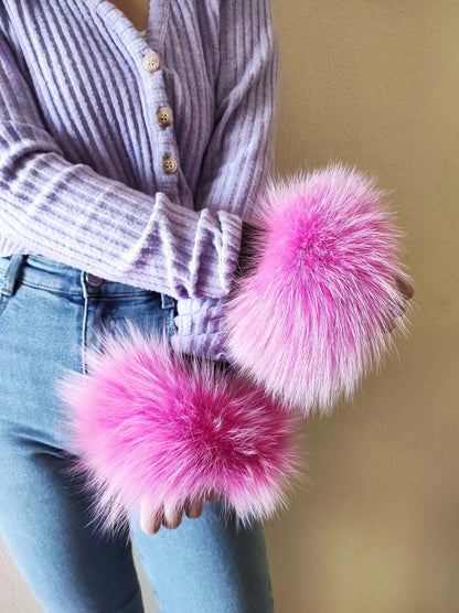 Fuchsia Fox Fur Cuffs - Tatifurs worn on wrists, showcasing vibrant fuchsia fox fur and stylish outfit.