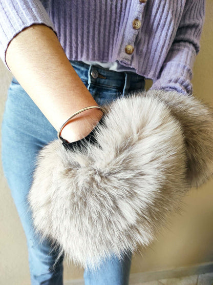 Gray Fox Fur Cuffs - Tatifurs on a wrist showcasing natural gray fur beauty and luxurious style.
