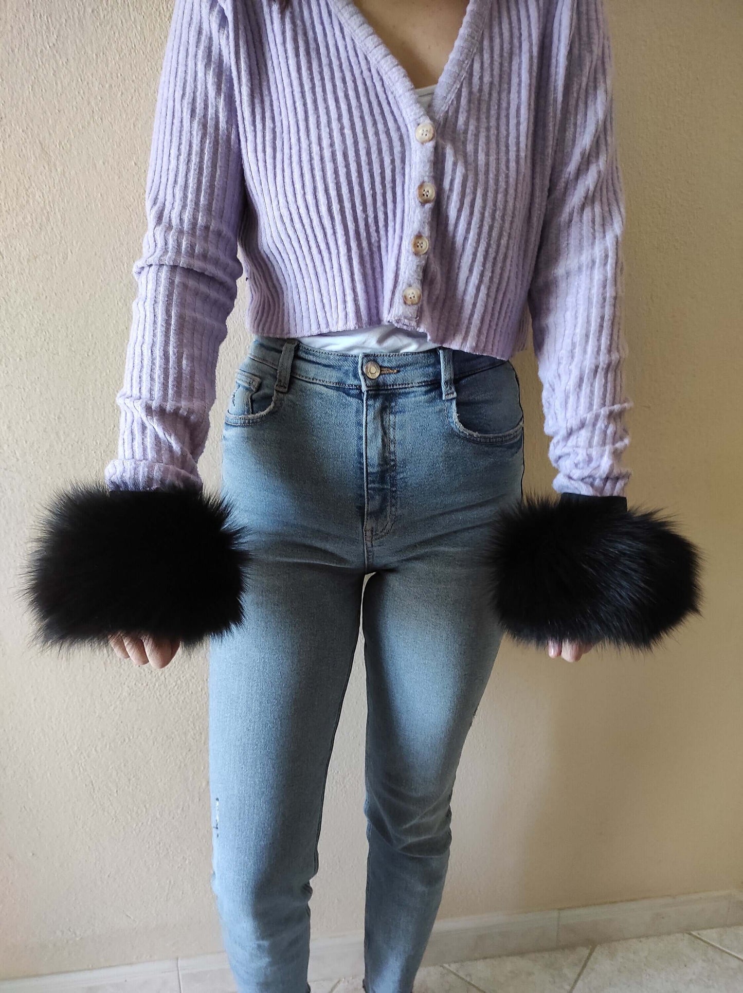 Black Fox Fur Cuffs - Tatifurs worn with a lilac cardigan and jeans, showcasing elegant and stylish accessory.