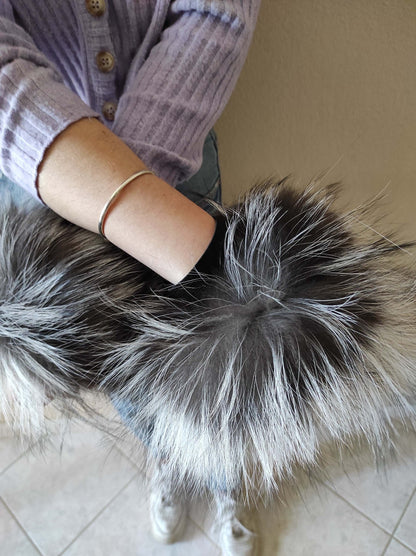 Natural Silver Fox Fur Cuffs - Tatifurs worn by a model showcasing their luxurious texture and color.