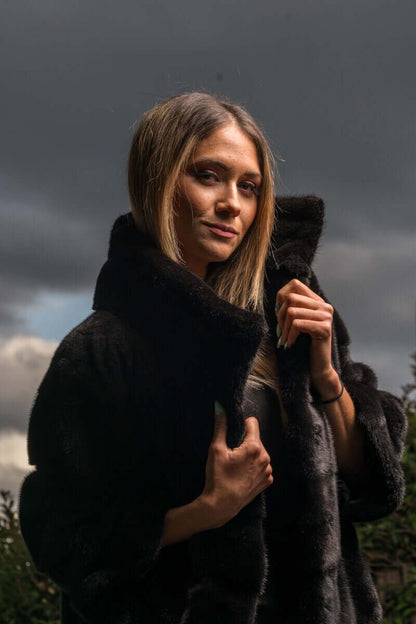 Mink Fur Jacket Black with collar - Tatifurs on model against dramatic sky.