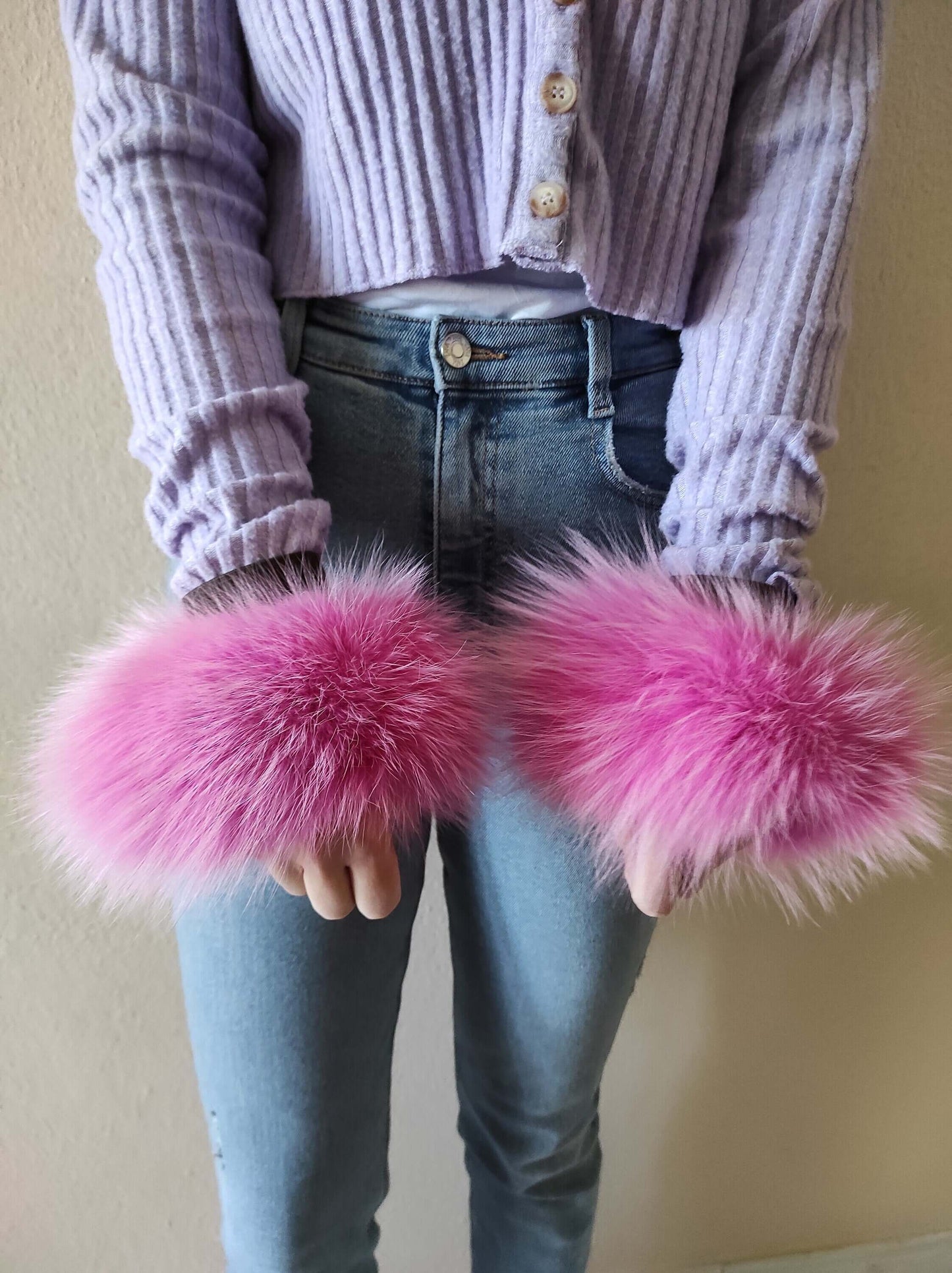 Fuchsia Fox Fur Cuffs - Tatifurs worn on wrists, showcasing vibrant fuchsia pink fur in a stylish outfit.