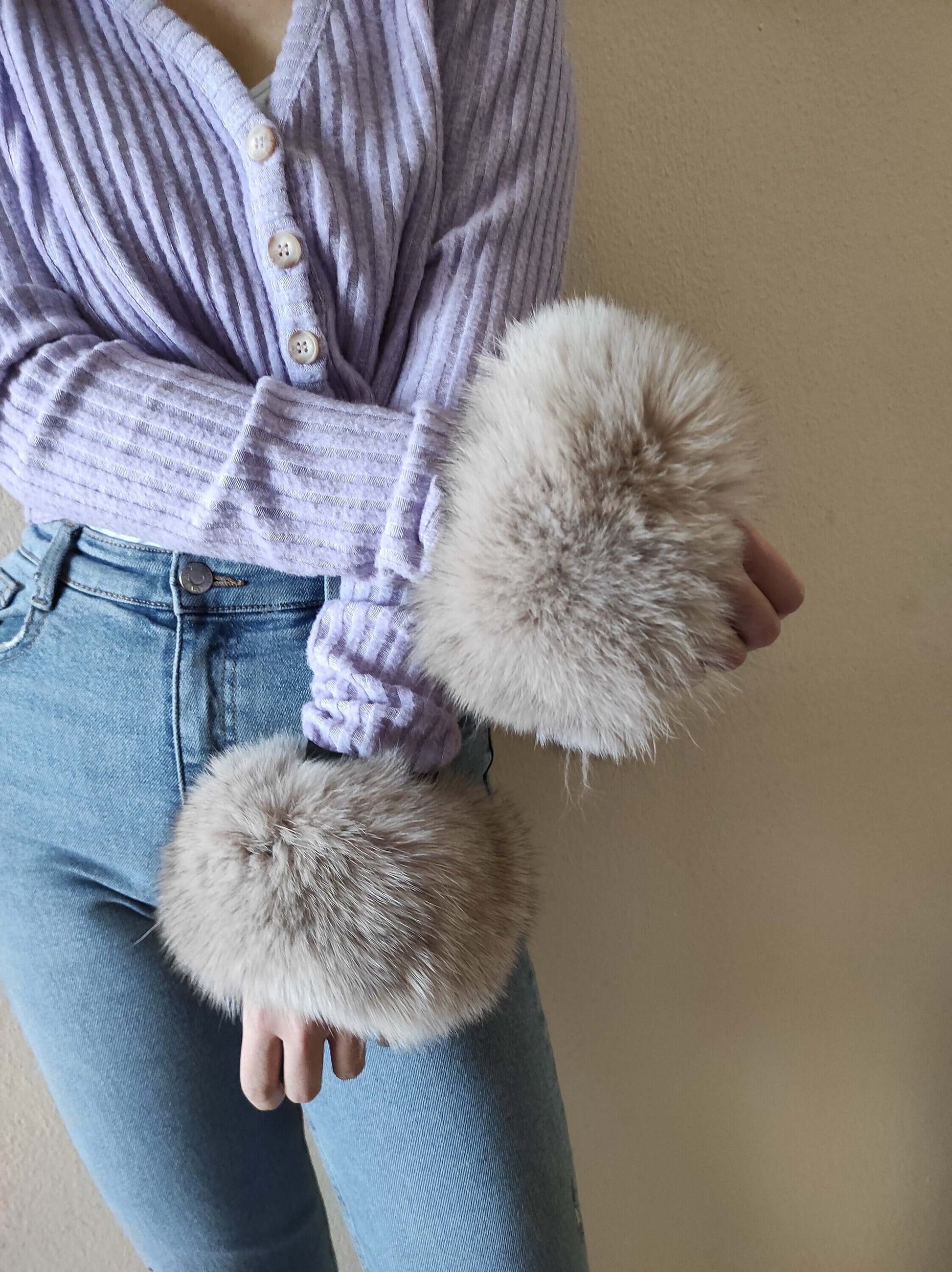Gray Fox Fur Cuffs - Tatifurs worn on wrists with a soft lavender sweater and denim jeans.
