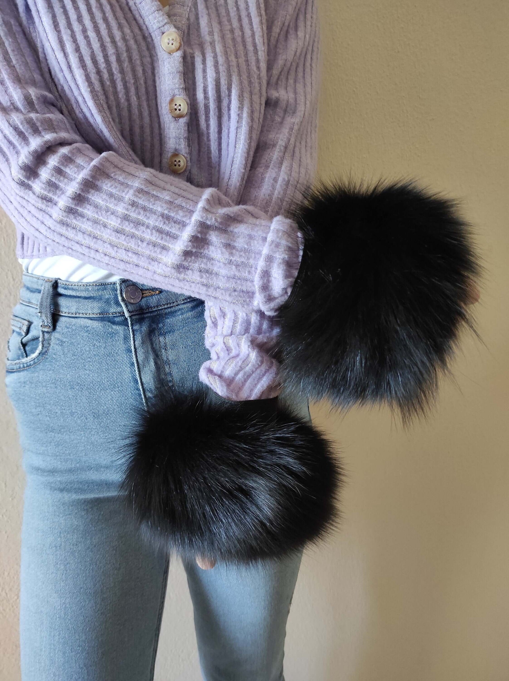Black Fox Fur Cuffs - Tatifurs worn with a purple sweater, showcasing the luxurious black fur style.