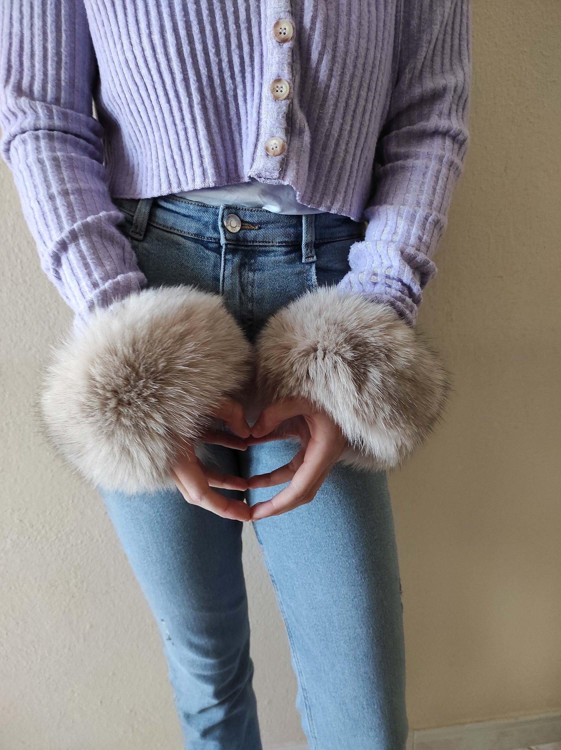 Gray Fox Fur Cuffs - Tatifurs worn on wrists, showcasing natural gray fox fur in cool silver-gray tones.