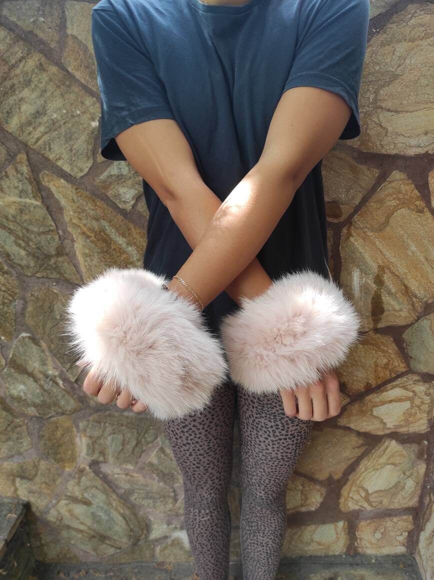 Baby Pink Fox Fur Cuffs - Tatifurs showcased on a model's wrists, emphasizing softness and luxurious style.