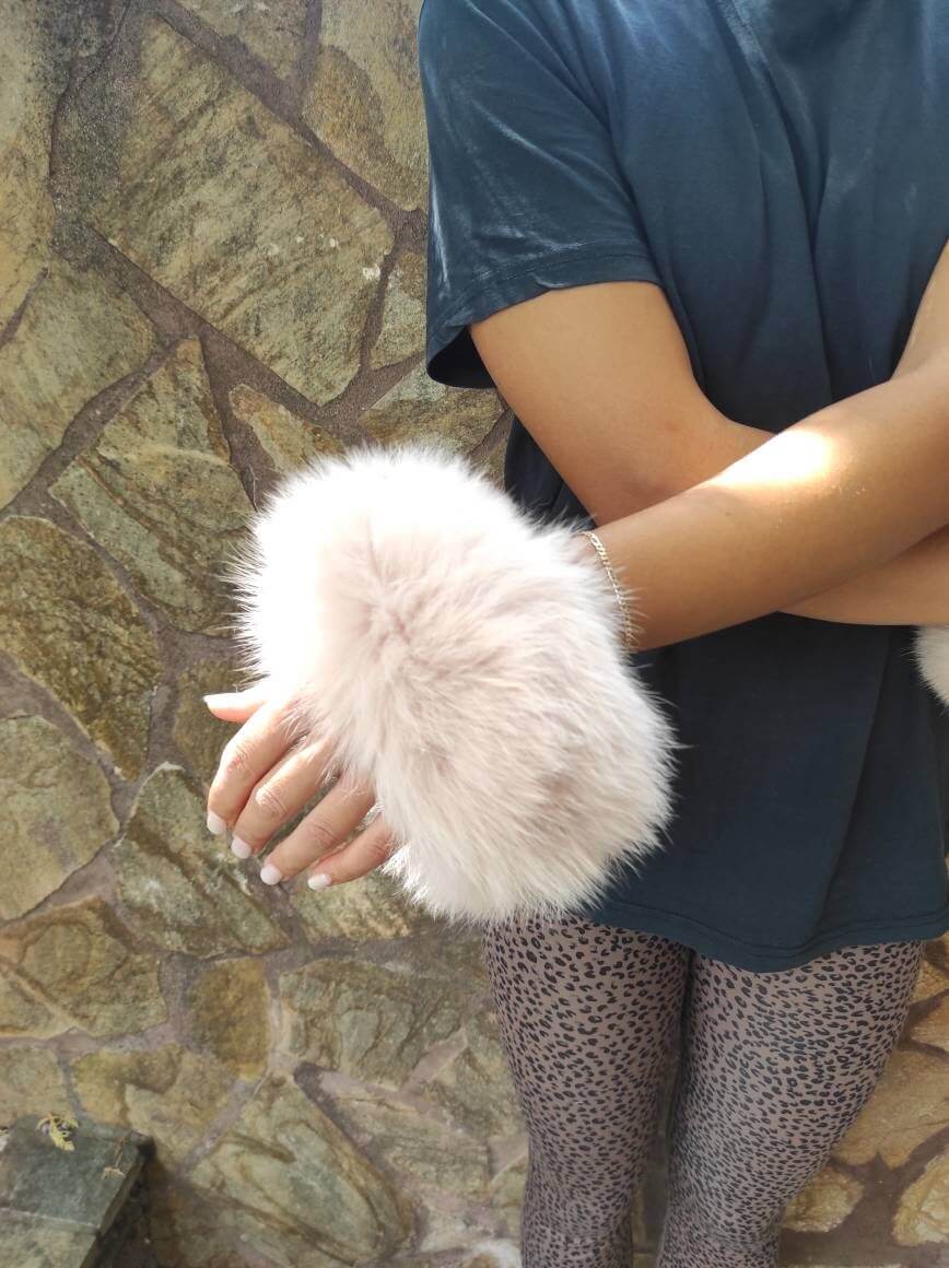 Baby Pink Fox Fur Cuffs - Tatifurs worn on wrists, showcasing soft and luxurious baby pink fur.