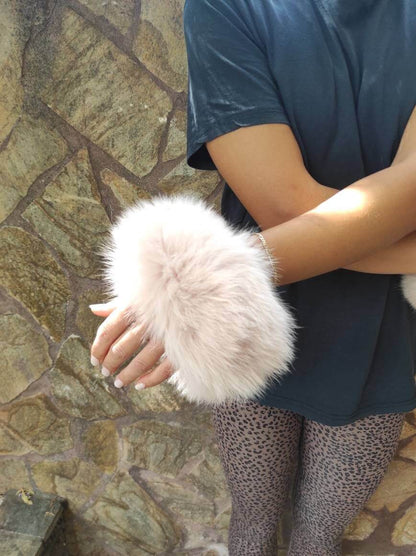 Baby Pink Fox Fur Cuffs - Tatifurs worn on wrists, showcasing soft and luxurious baby pink fur.