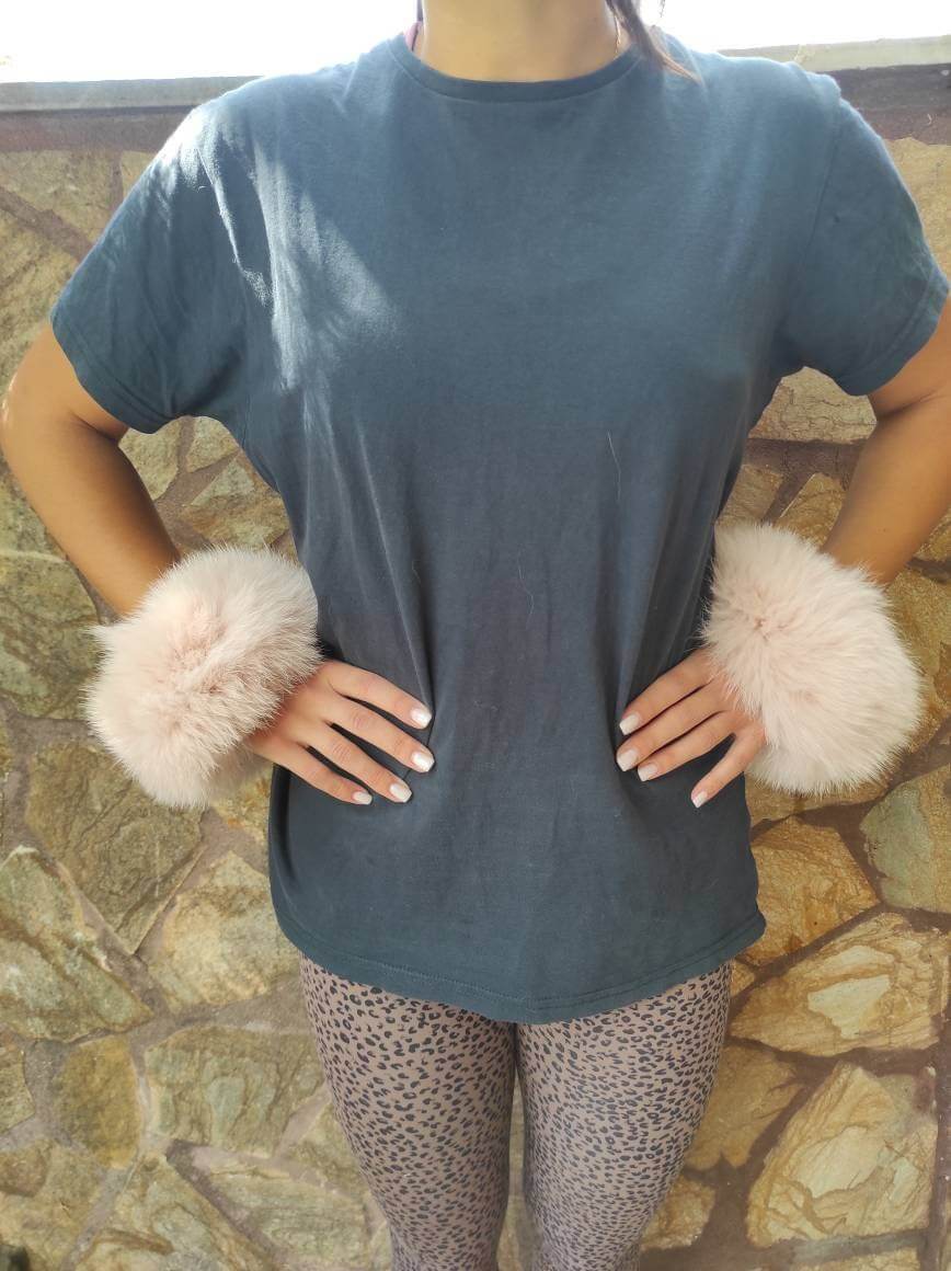 Model wearing Baby Pink Fox Fur Cuffs - Tatifurs with a casual outfit, showcasing the elegant design and soft texture.